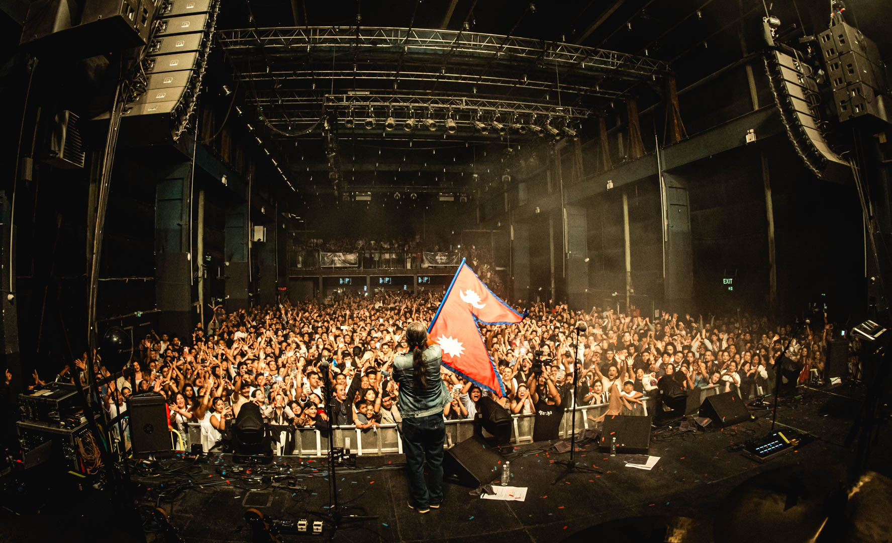 02-Nepathya-frontman-Amrit-Gurung-waves-Nepali-flag-at-the-concert-in-Copenhagen.-Photo-Dipit-Raz---nepalaya-1756192269.JPG